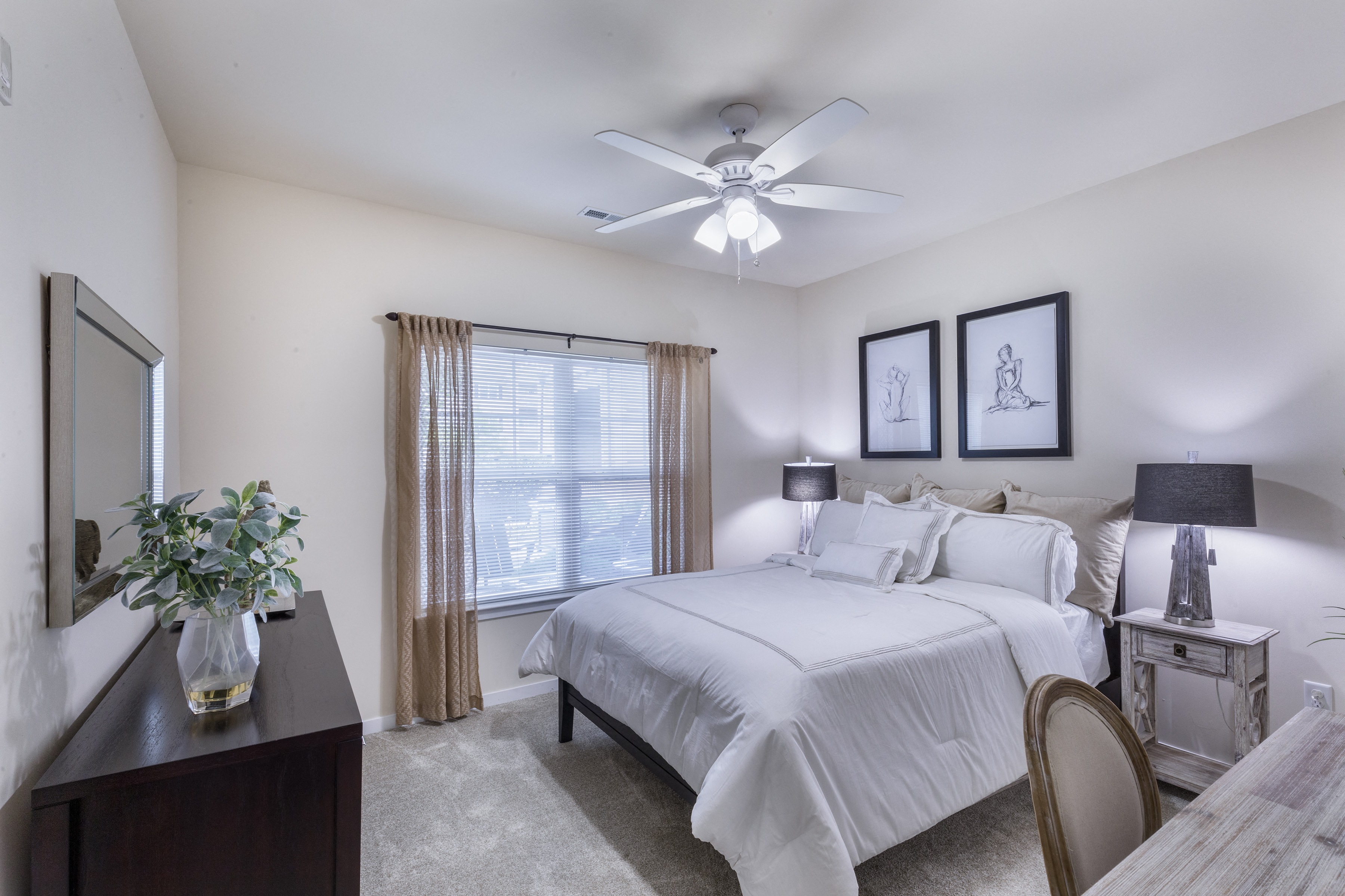 a bedroom with a large bed and a ceiling fan at Aventura at Forest Park, Missouri, 63110